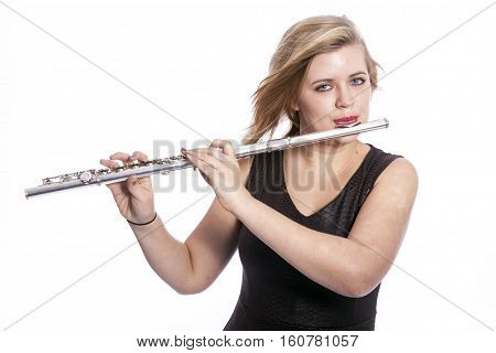 young caucasian blond woman plays the flute against white background in studio