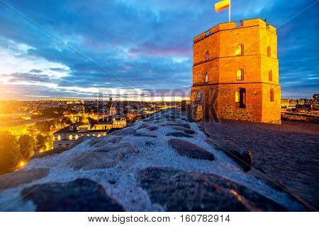 View on the illuminated old tower on the castle hill in the old town of Vilnius city in Lithuania. This tower is very popular tourist destination in Vilnius