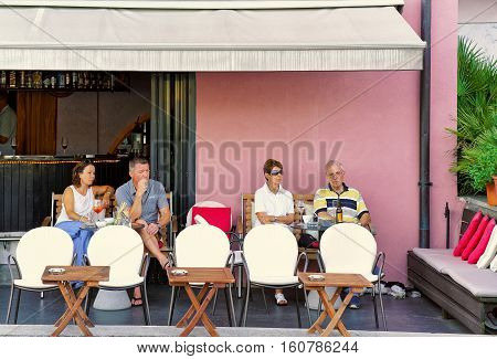 People Relaxing In Street Restaurant In Ascona Town Of Swiss