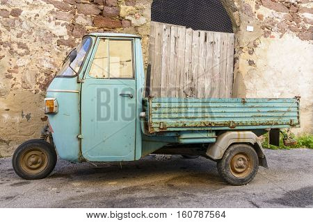 Motocarro old three-wheeled light blue. Old Italian motocarro