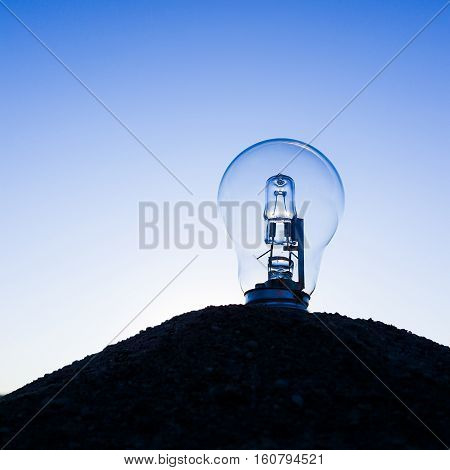 Light bulb in sand. Innovation and idea concept