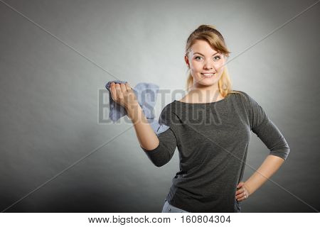Chores housework silly hygiene clean concept. Blonde maid enjoying her work. Young girl dancing waving around dirty rag cleaning.