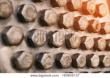 bolts and nuts in machinery for repair and service which old condition. damage of bolts and nuts of machine equipment. Industry background with many bolts and nuts in workshop for maintenance.
