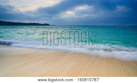 Long exposure Wave of the sea on the sand beach