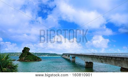 Sightseeing View of The Kouri Bridge with blue sky one of the very long bridge in Okinawa Japan