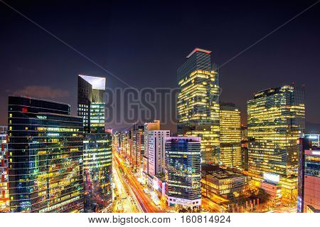 Cityscape of South Korea. Night traffic speeds through an intersection in the Gangnam district of SeoulSouth Korea.