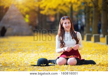 Beautiful Girl With Yellow Leaves In Nami Island, Korea. Nami Island In Autumn.