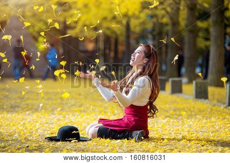 Beautiful Girl with Yellow Leaves in Nami Island Korea. Nami island in autumn.