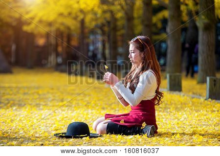 Beautiful Girl with Yellow Leaves in Nami Island Korea. Nami island in autumn.