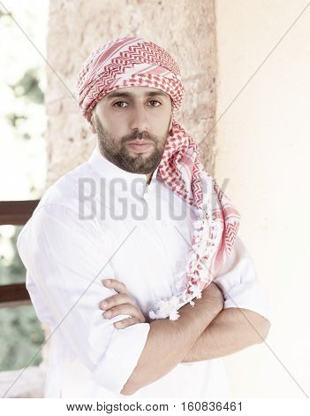 Young smiling handsome arabian man wearing traditional clothes