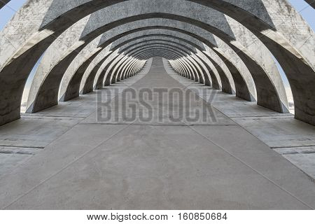 Concrete hovering arcade passage loses itself in infinitiy