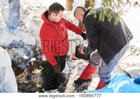 Tourists the process of cooking food on a fire