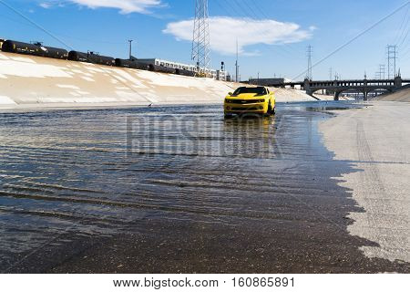 Los Angeles USA - September 28 2015: Chevrolet Camaro in Los Angeles river. Historic 6th Street viaduct bridge built in 1932 crossing the L.A. River.