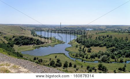 The view from the height of the river, which flows into the reservoir