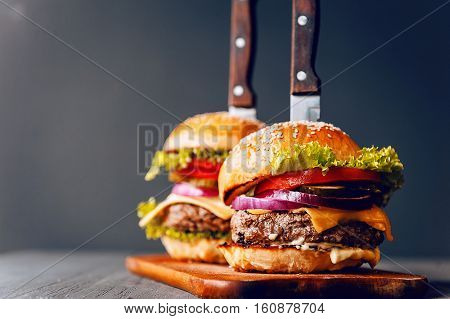 Two Mouth-watering, Delicious Homemade Burger Used To Chop Beef. On The Wooden Table.
