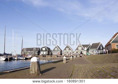 Marken, Netherlands, 22 november 2016: old wooden houses at harbor of old dutch village Marken on sunny day in november