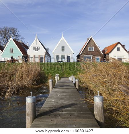 Durgerdam, Netherlands, 22 november 2016: jetty and old wooden houses on the dike of durgerdam near amsterdam in the netherlands