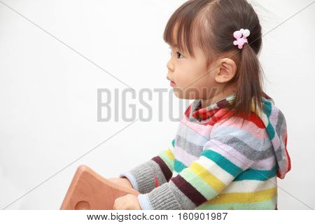 Japanese girl playing with rocking horse (2 years old)