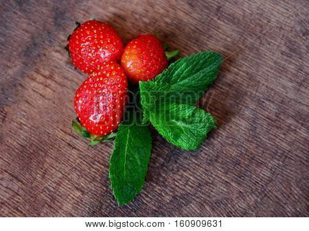 Juicy strawberries and mint on the table