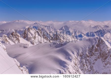 Alps view from Mt. Titlis in winter. Titlis is a mountain located on the border between the Swiss Cantons of Obwalden and Bern.
