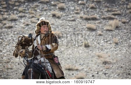 Bayan Ulgii Mongolia October 4th 2015: Eagle hunter riding a horse