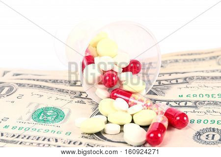 small heap of paper dollars and medical drugs