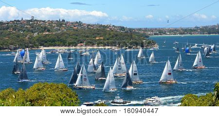 Sydney Australia - December 26 2013. Participants yachts in Sydney Harbour after the start. Sydney to Hobart Yacht Race is an annual event starting in Sydney on Boxing Day and finishing in Hobart.