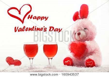 Romantic still life with red wine and beautiful pink rebit. Happy Valentine's day concept