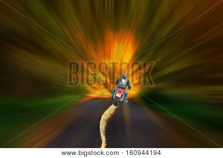 Motorcyclist with burning tire against a blurred abstract background.