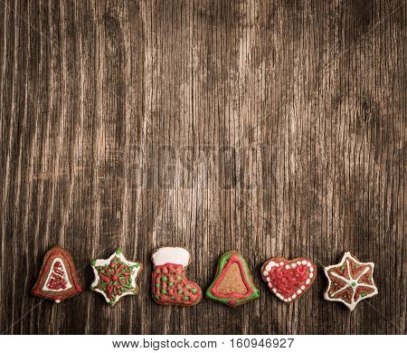 Colorfully Christmas Cookies On Rustic Wooden Background, Gingerman And Tree
