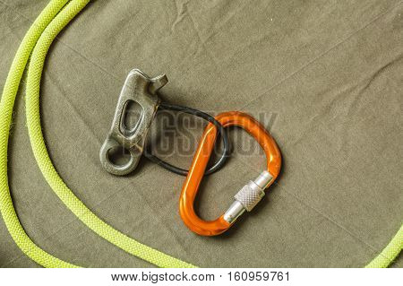 Belay Device, D-shaped Carabiner And Rope.