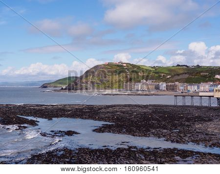 View of Aberystwyth on the Ceredigion coast Wales looking towards Constitution Hill together with the end of the Royal Pier.
