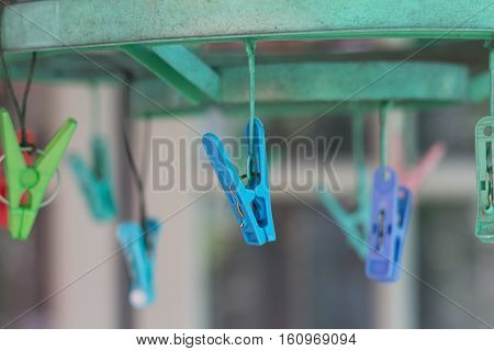 Clothes pegs or clothespins hang on a cord. Plastic clothes pegs on a washing line.(selective focus)