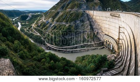 The Enguri hydroelectric power station HES. Inguri River next to Enguri Dam surrounded by mountains Upper Svaneti Georgia. Second highest concrete arch dam in the world. Jvari location.