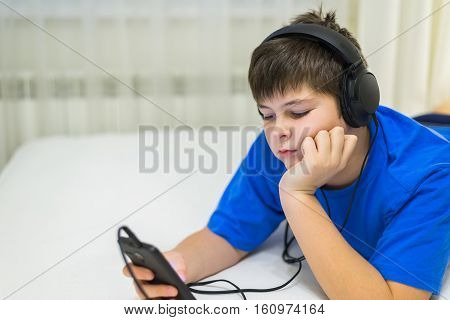 Teen using cell phone with a headphones