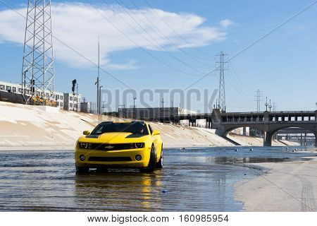 Los Angeles USA - September 28 2015: Chevrolet Camaro in Los Angeles river. Historic 6th Street viaduct bridge built in 1932 crossing the L.A. River.