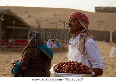 DUBAI, UAE - APRIL 20 2012: Staff at a desert safari camp prepares food in preparation for tourists arriving after dune bashing