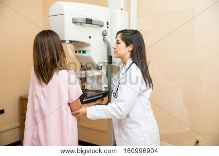 Doctor Helping Patient Get A Mammogram