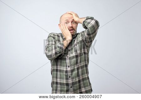 Nervous Scared European Guy Has Sorrorful Expression, Holding Hands On Head Finds Out About Tragic E