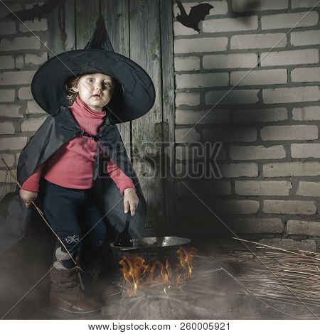 Little Witch Making A Magic Potion At Halloween Night. Horror.