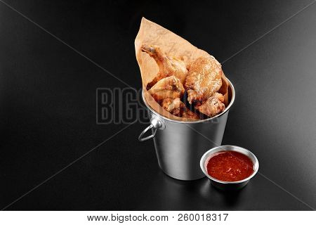 Bbq Chicken Wings In A Metal Bucket Onblack Background With Sauce Menu