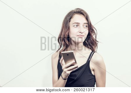 Beautiful Young Girl Holding A Phone. Makes Photos, Selfies