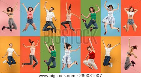 Freedom In Moving. Pretty Happy Young Women And Man Jumping And Gesturing Against Colorful Studio Ba