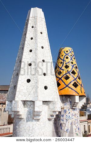 BARCELONA, SPAIN - OCTOBER 2:The mosaic chimneys made of broken ceramic tiles on roof of Palau GÃ¼ell , one of the earlest Gaudi's  masterpieces  on October 02, 2011 in Barcelona, Spain