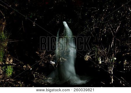 Long Exposure Photograph With Lightpainting Technique Representing An Illuminated Man.