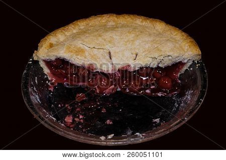 Slice Of Double Crusted Cherry Pie On Black Background. Traditionally, Cherry Pie Is Made With Tart 