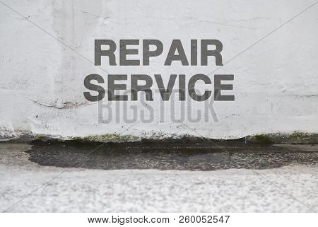 Text Repair Service Over A Damaged Wet Wall That Needs Renovation