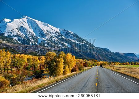 Highway in Colorado Rocky Mountains at autumn, USA. Mount Sopris landscape.