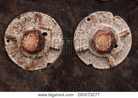 Two Large Heavy Old Vintage Rusted Bolts On A Weathered Wood Wall, Grunge Background Texture