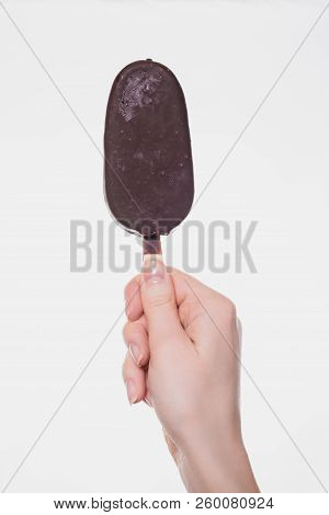 Vertical Close Up Photo Of Tasty Delicious Yummy Chocolate Glazed Ice-cream In Woman's Hand Isolated